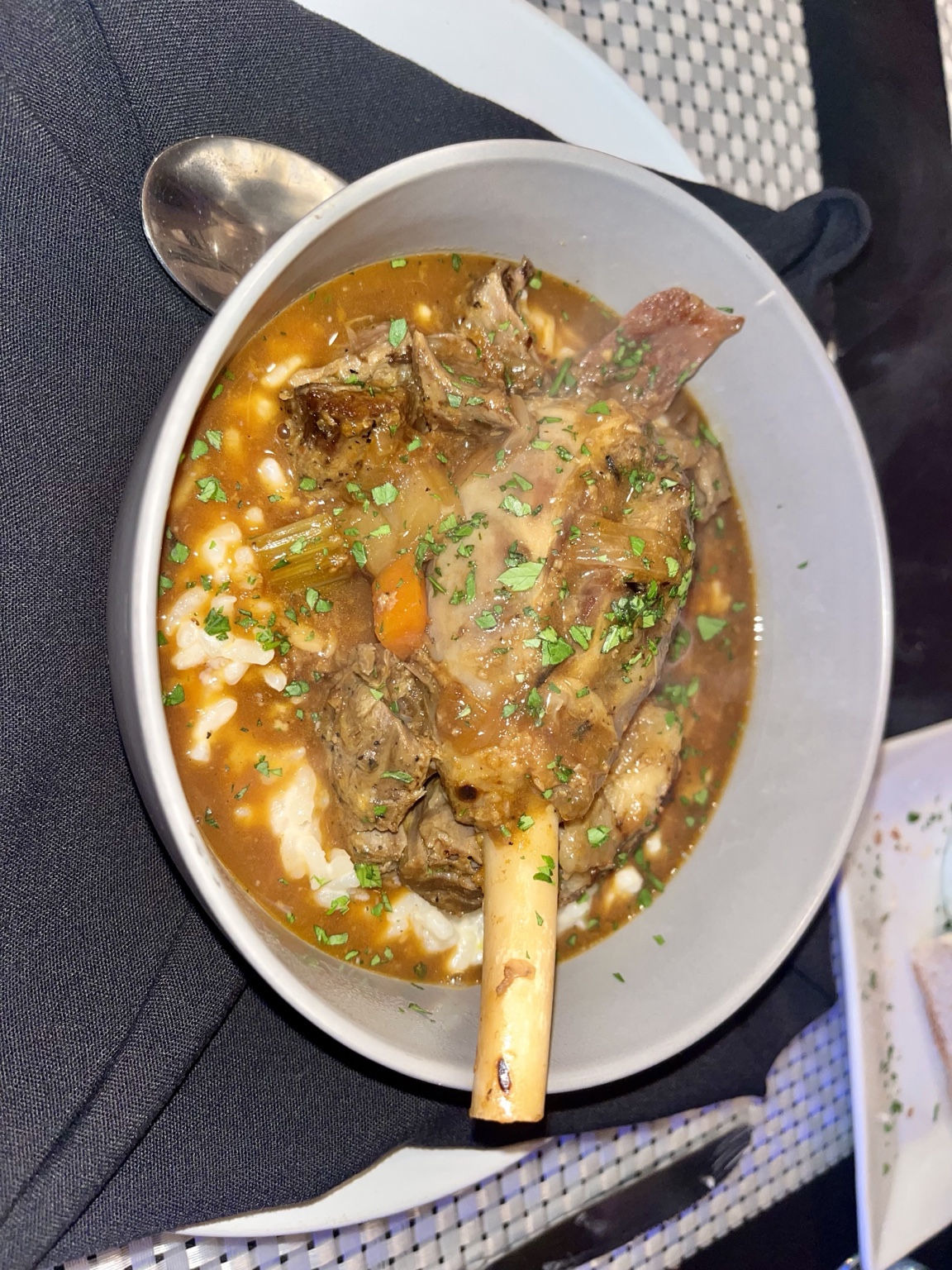 Braised bone-in shank in broth with rice, carrots, celery and herbs