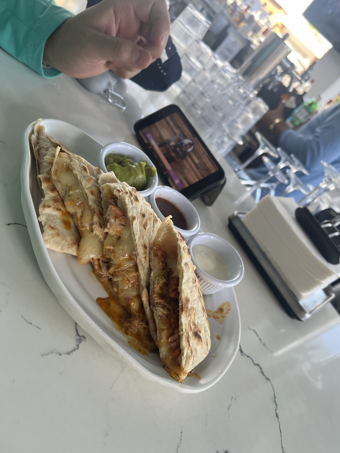Folded flatbreads filled with chicken and melted cheese with three sauces