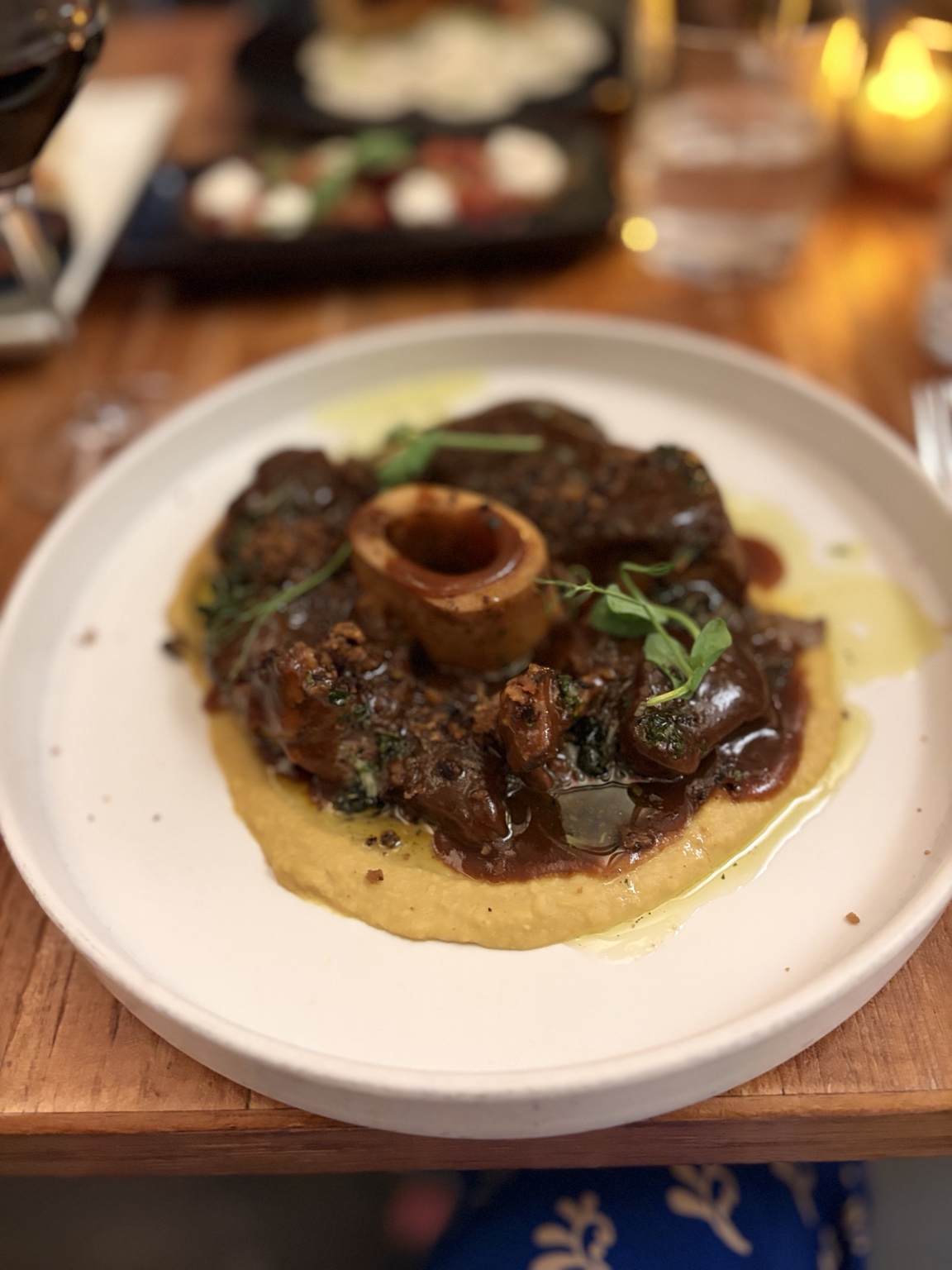 Slow-braised meat with marrow and glossy sauce over golden puree