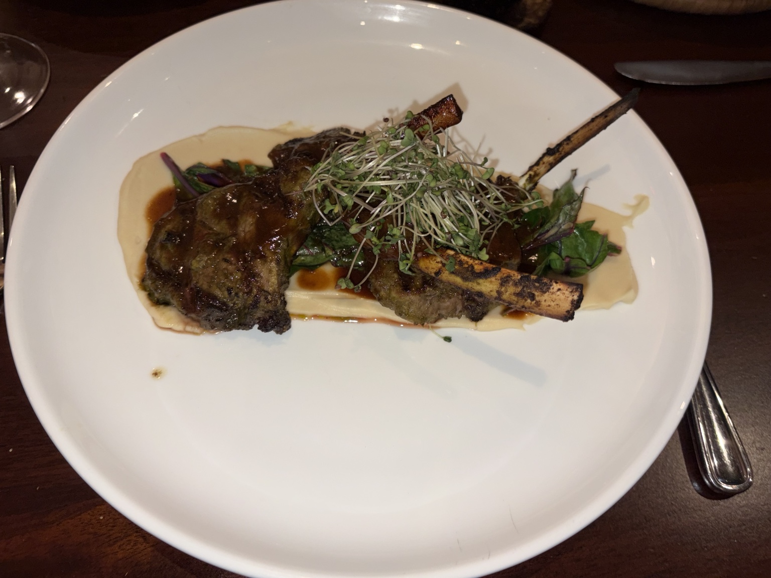 Glazed lamb chops over potato puree with greens and sprouts