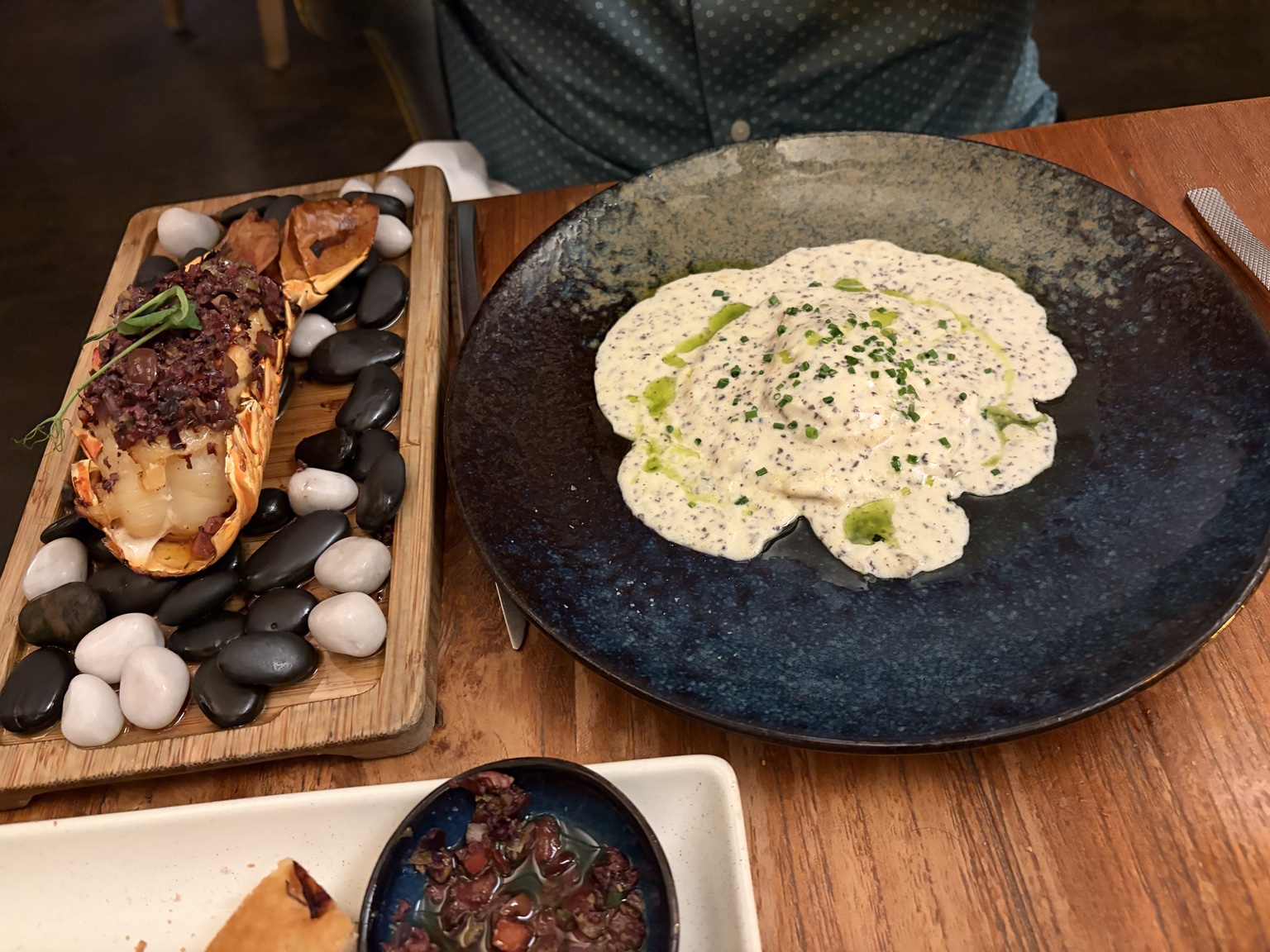 Split lobster tail served with creamy filled pasta