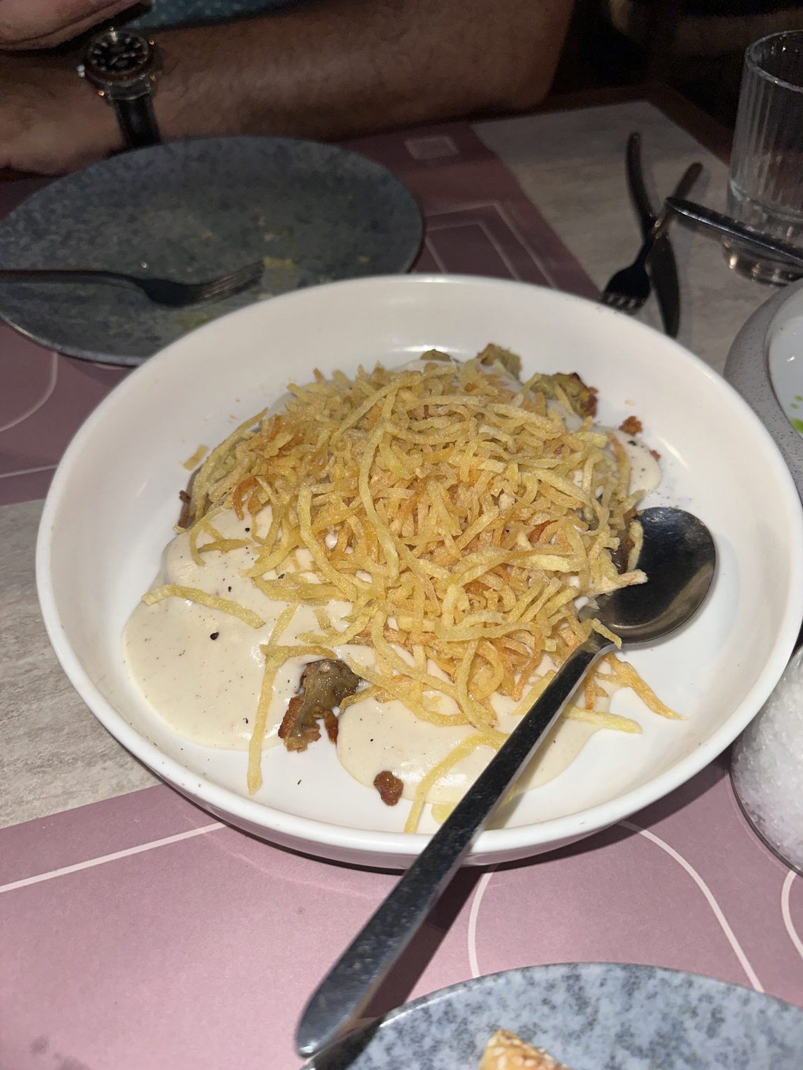 Creamy vegetable dish topped with thin golden potato crisps