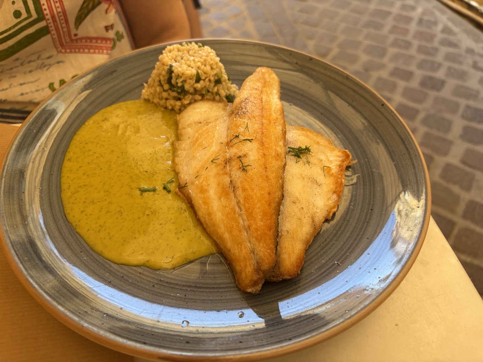 Pan-seared fish fillets with golden herb sauce and seasoned grains
