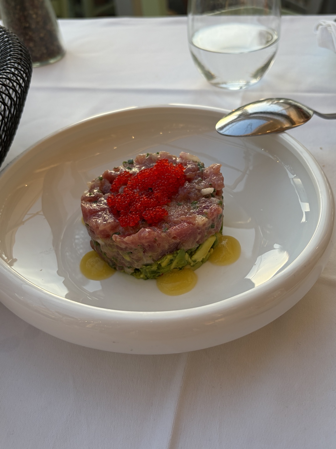 Tuna tartare layered over avocado and topped with red roe