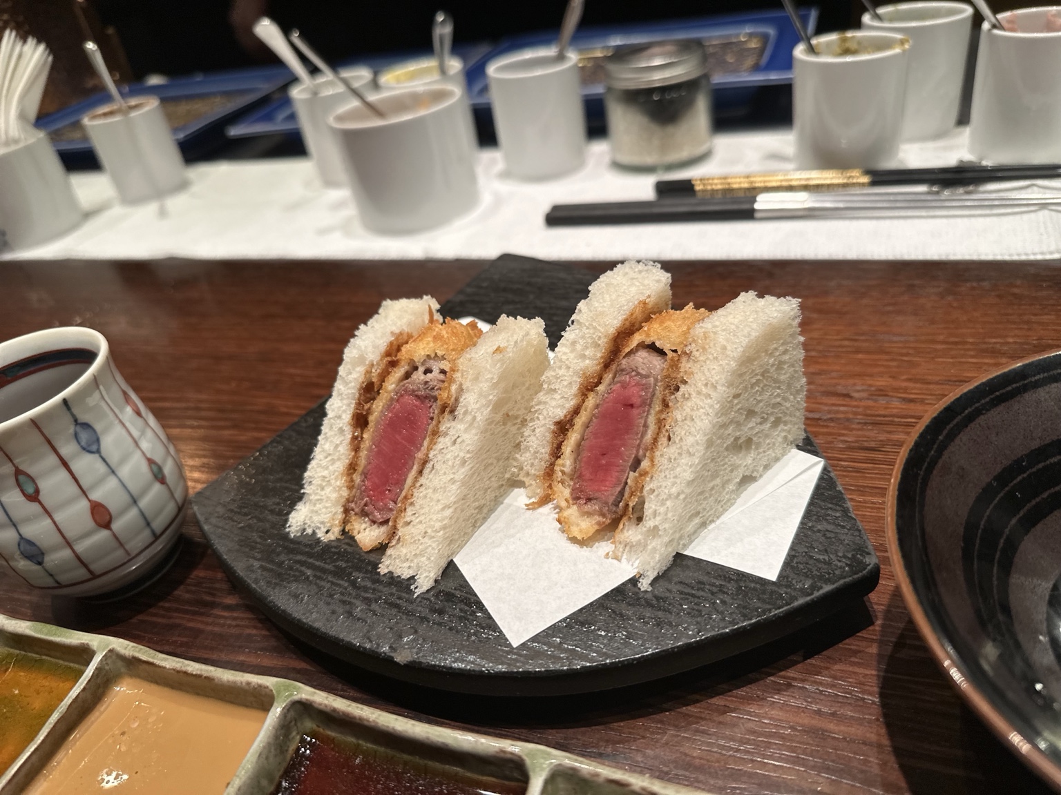Two thick beef katsu sandwiches with rosy centers