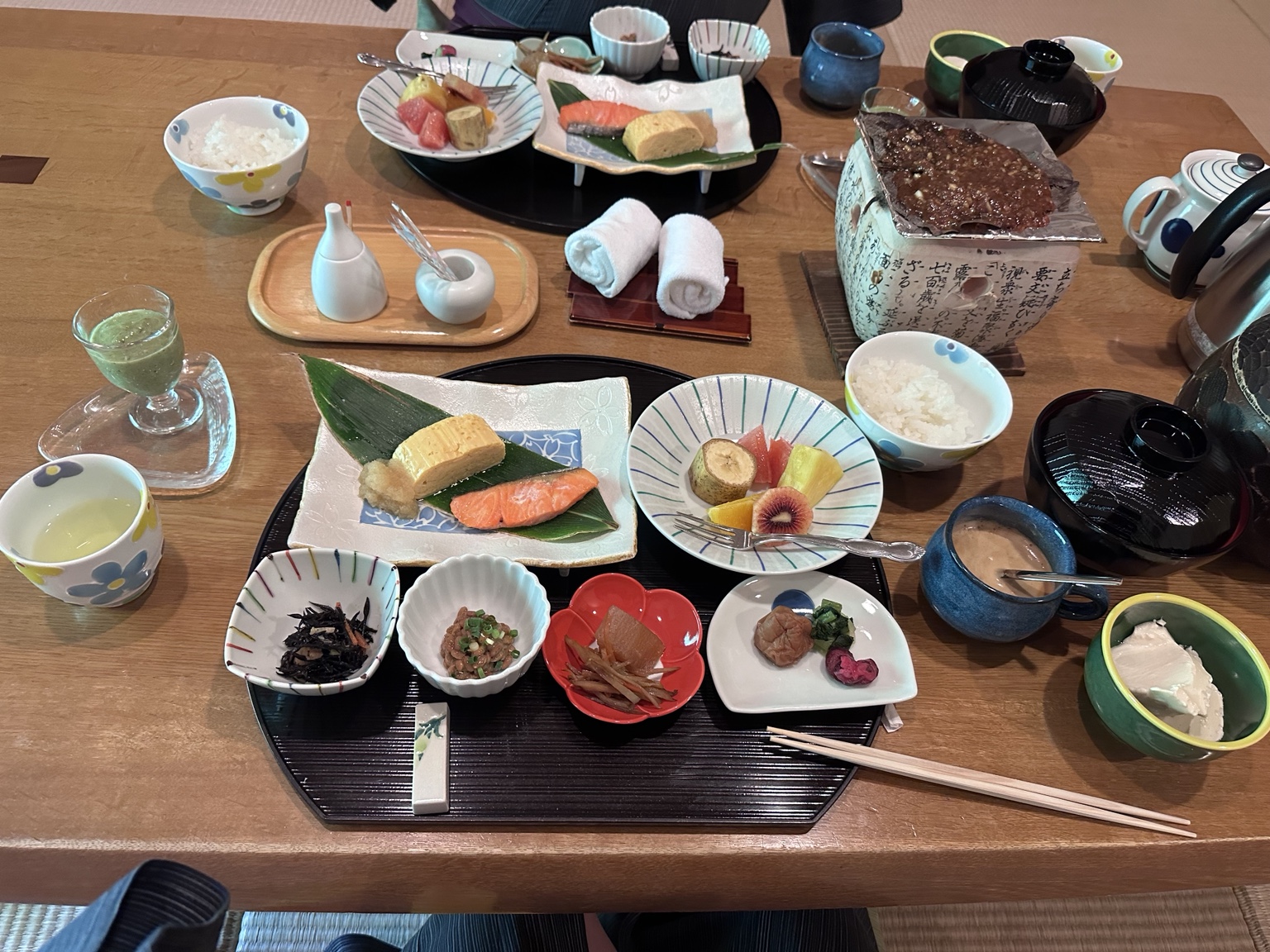 Traditional Japanese breakfast with salmon, rolled egg, rice, soup and small dishes