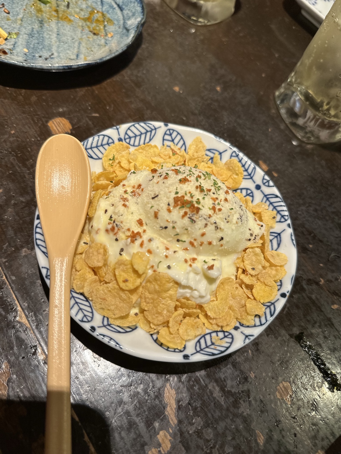 Creamy savory scoop surrounded by cornflakes and seasoning