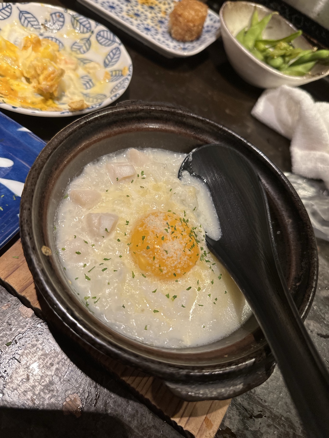 Creamy rice bowl topped with egg yolk and herbs