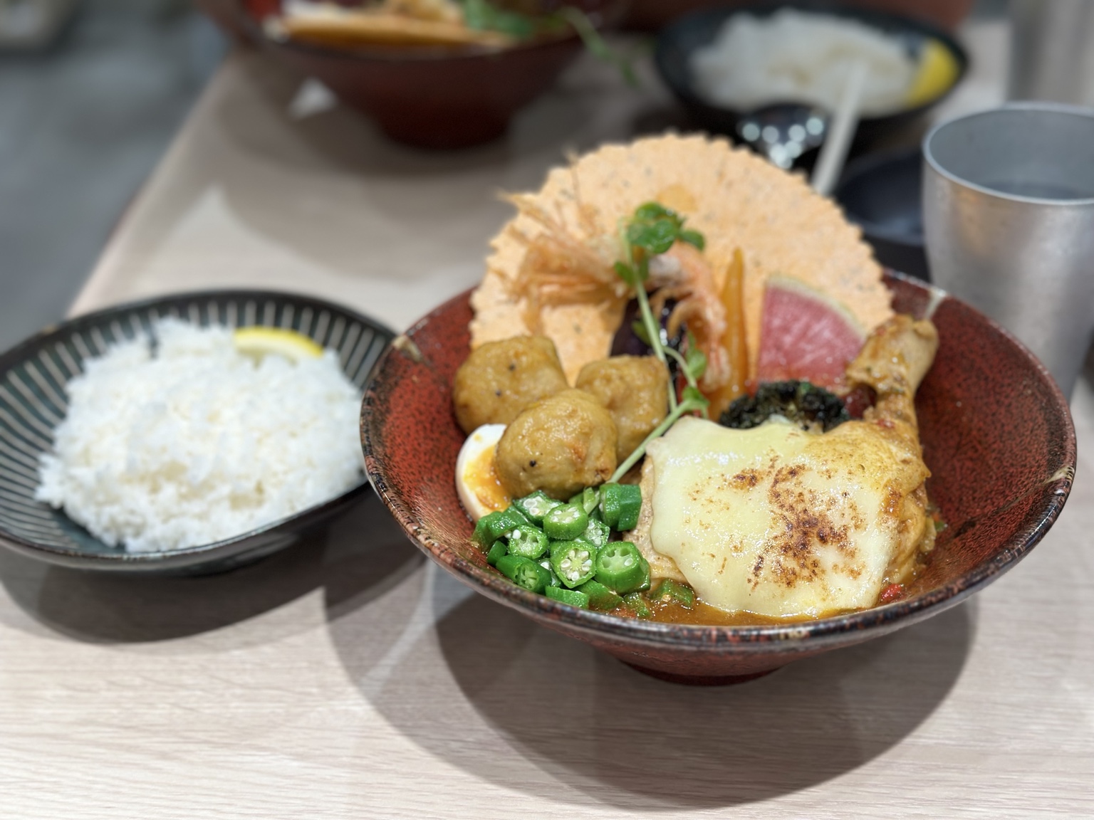 Japanese soup curry with chicken, vegetables, egg, cheese and rice