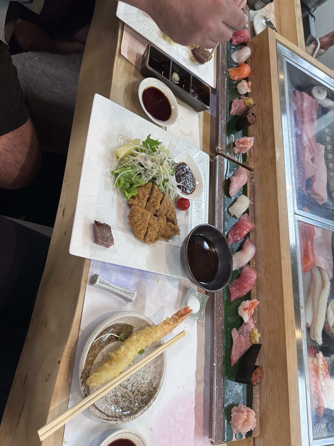Long sushi platter with nigiri, shrimp tempura and breaded cutlet