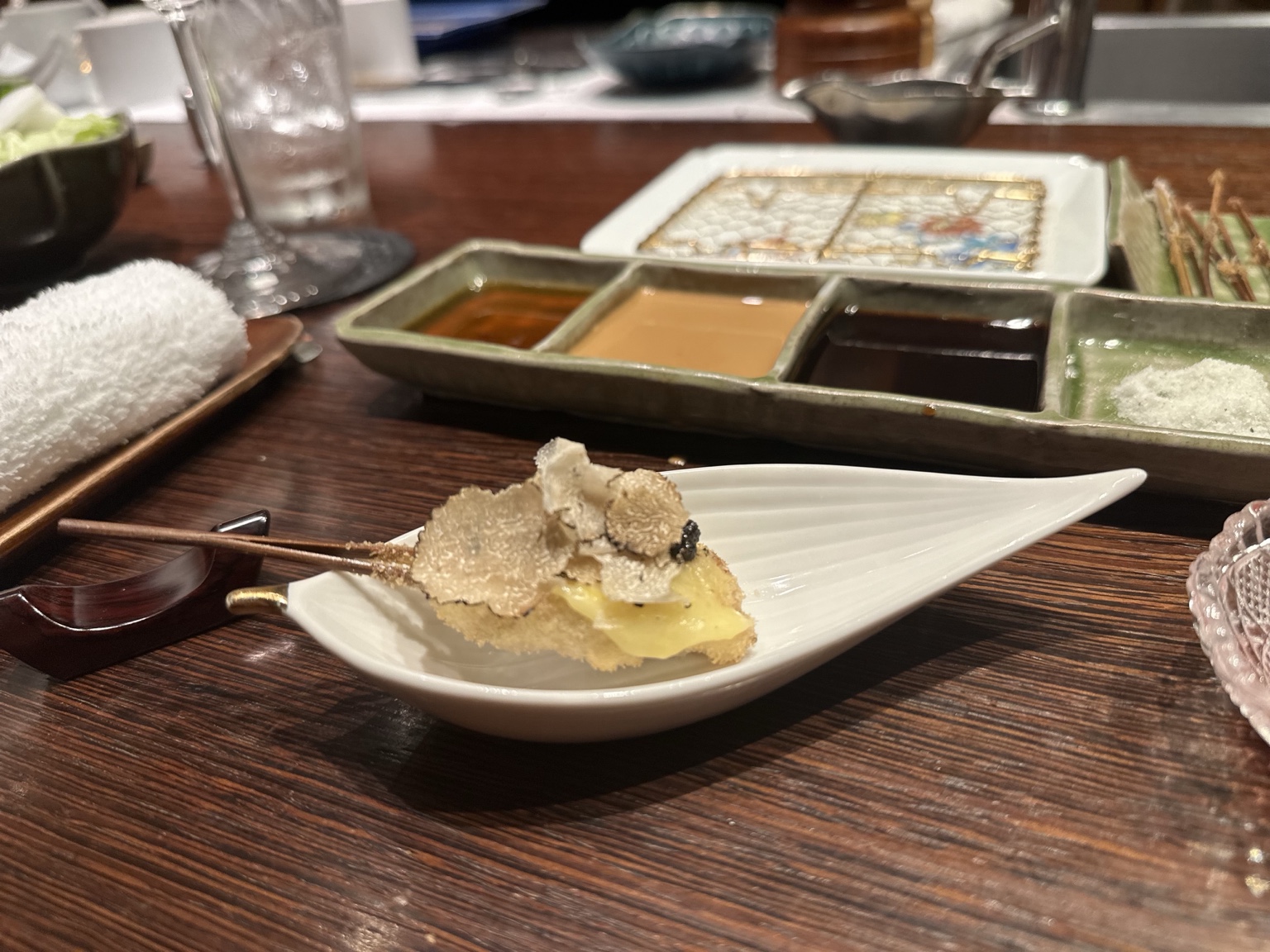 Small toast topped with cheese, caviar and shaved truffle