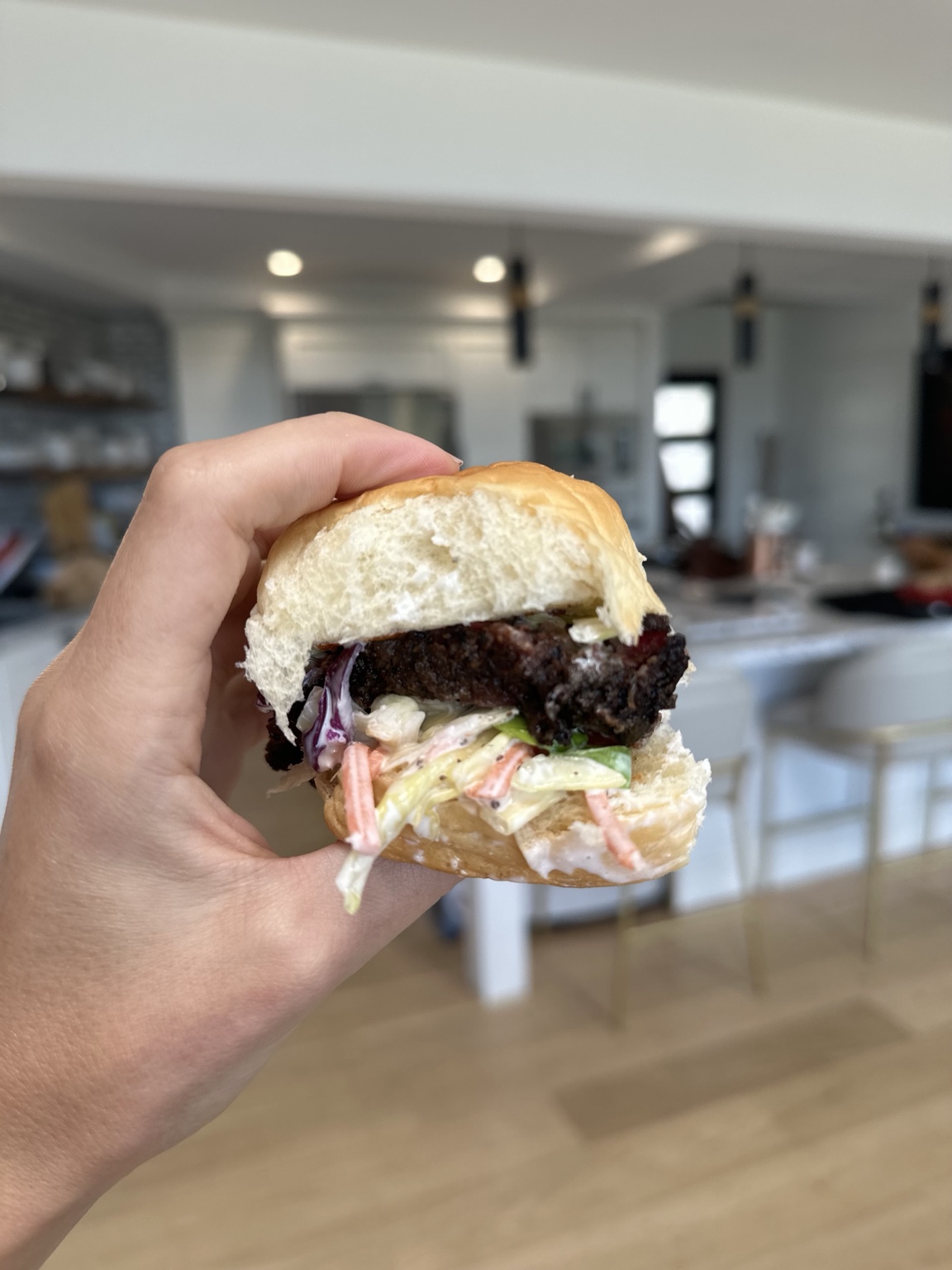 Homemade beef burger with pickles and creamy cabbage slaw