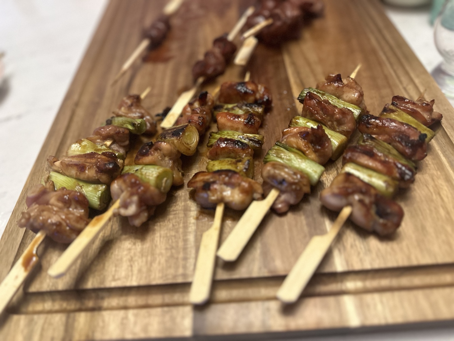 Grilled chicken and scallion skewers with a glossy glaze