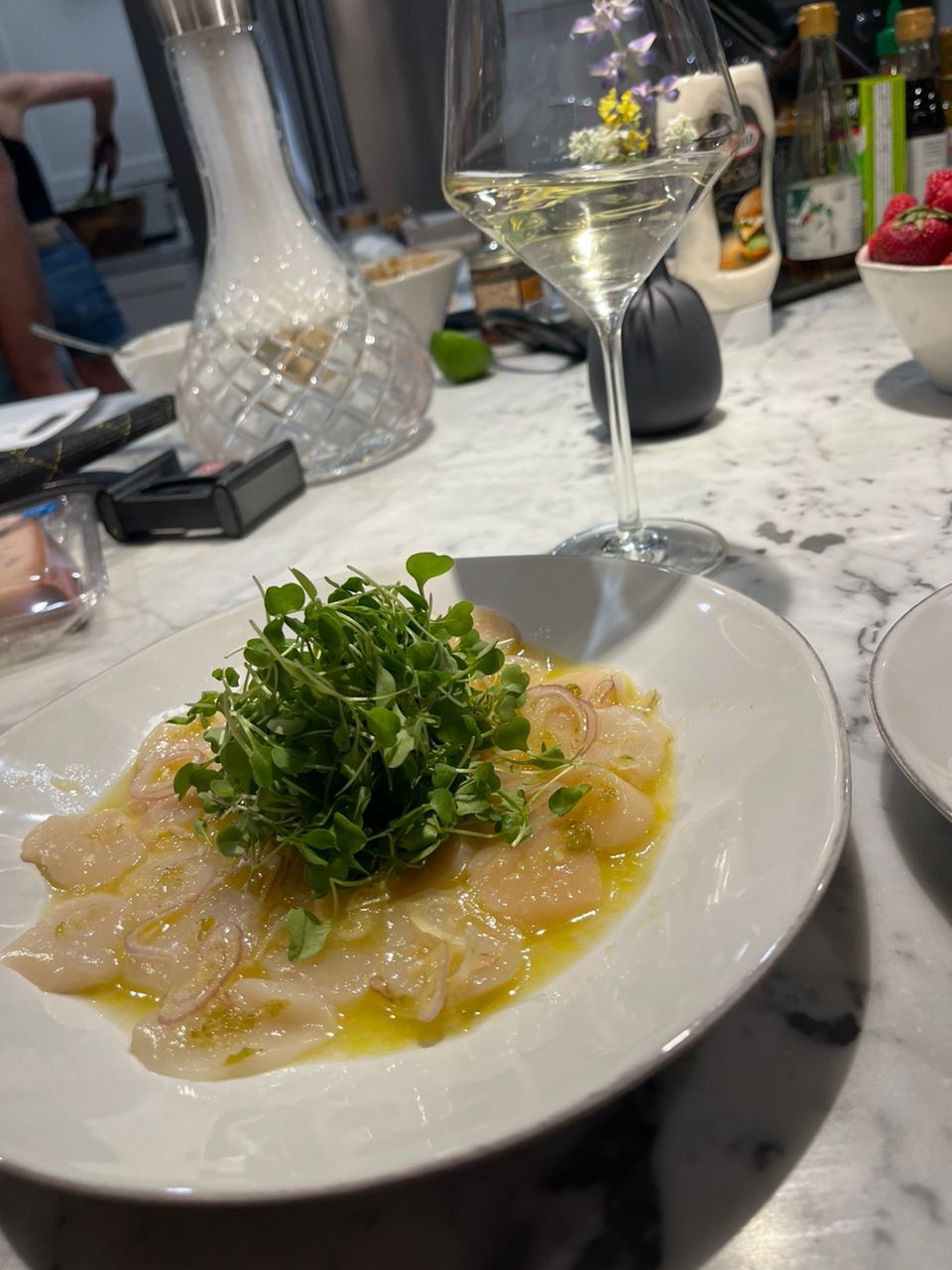 White-fish crudo with citrus dressing, shallots and fresh greens